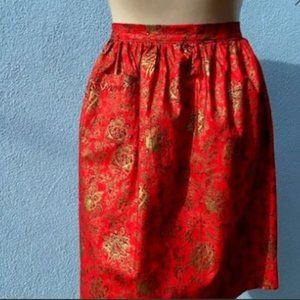 This gorgeous vintage apron is from the 1950's holiday red with gold highlights